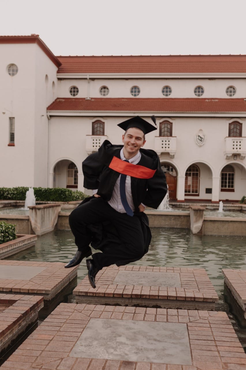 Jaco at graduation in cap and gown